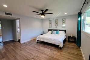 Primary bedroom with king sized bed and attached bathroom