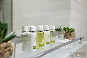 A bathroom shelf with various hair care products.
