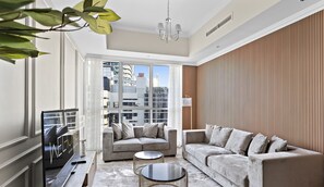 A modern living room with a sofa set, a coffee table, and a TV.