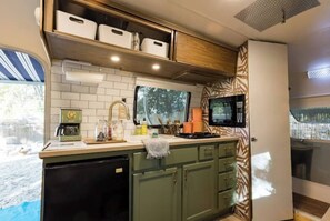 Microwave, stovetop, coffee/tea maker, cookware/dishes/utensils