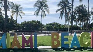 A sign with the words "MIAMI BEACH" in colorful letters. - Right on the beach, Ocean Drive Secured Condo (Miami Beach)