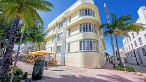 A curved, Art Deco-style building with a sign reading "The Ritz-Carlton". - Right on the beach, Ocean Drive Secured Condo (Miami Beach)