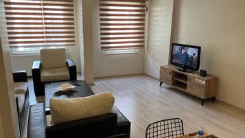 Deluxe Condo | Living area | 32-inch LED TV with satellite channels