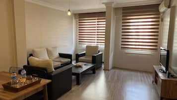 Deluxe Condo | Living area | 32-inch LED TV with satellite channels