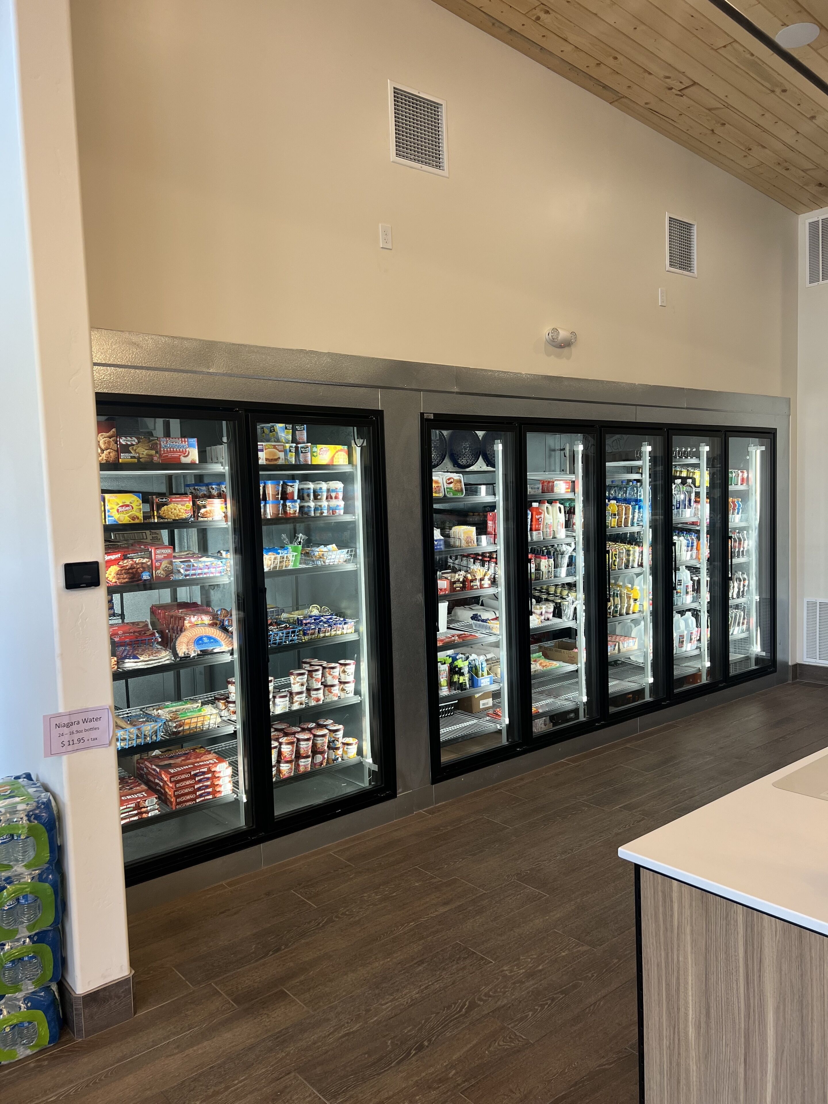 A refrigerated display case with various food items and beverages.