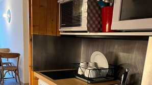 A compact kitchen with a dishwasher, a sink, and a microwave. - 50m from resort center, 7th floor, balcony, tv, 24m², Les Arcs (Les Arcs)