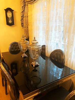 Enjoy meals in this classic dining area with a polished table and ornate chairs.