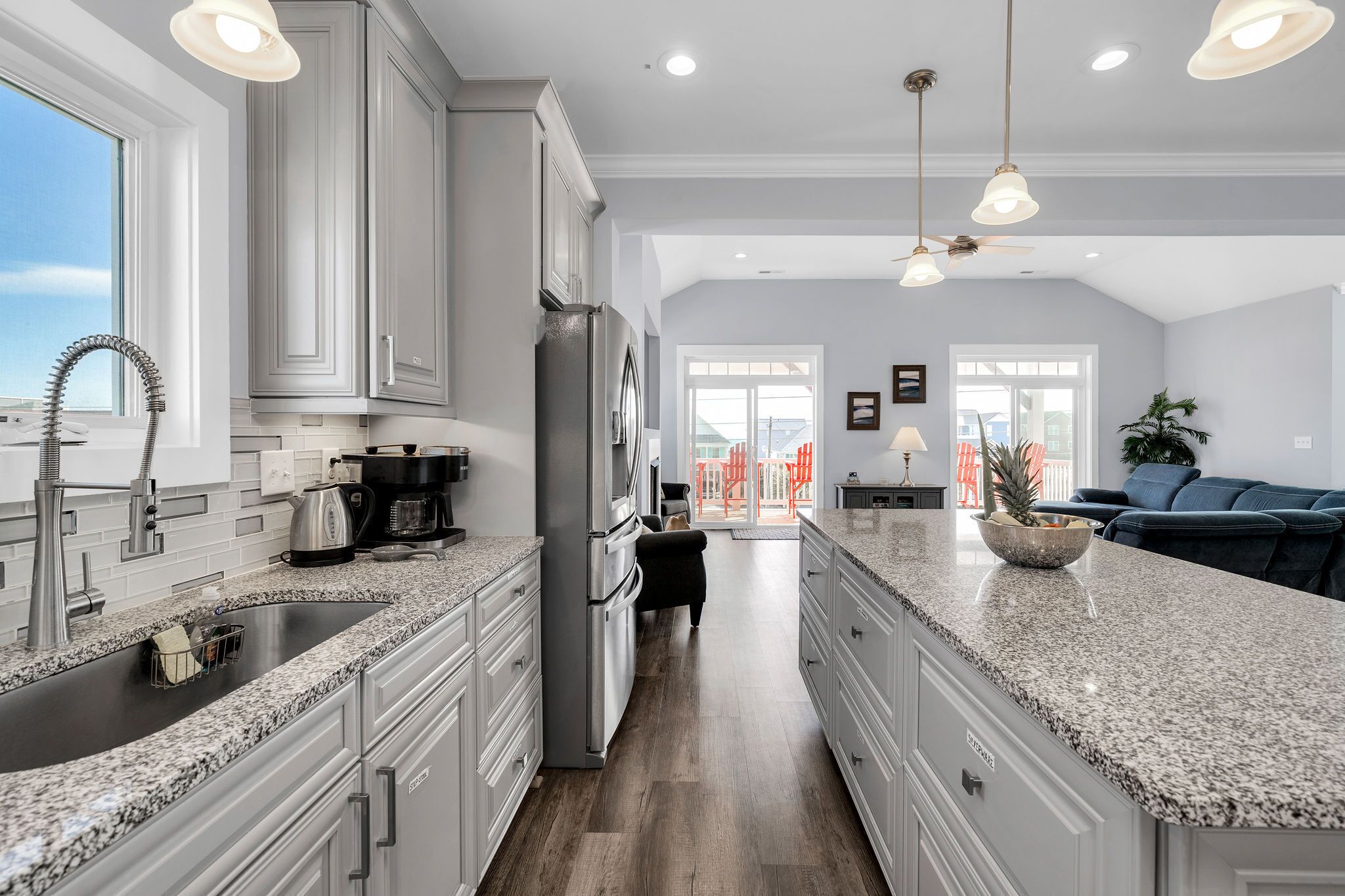 A modern kitchen with granite countertops, stainless steel appliances, and a central island.