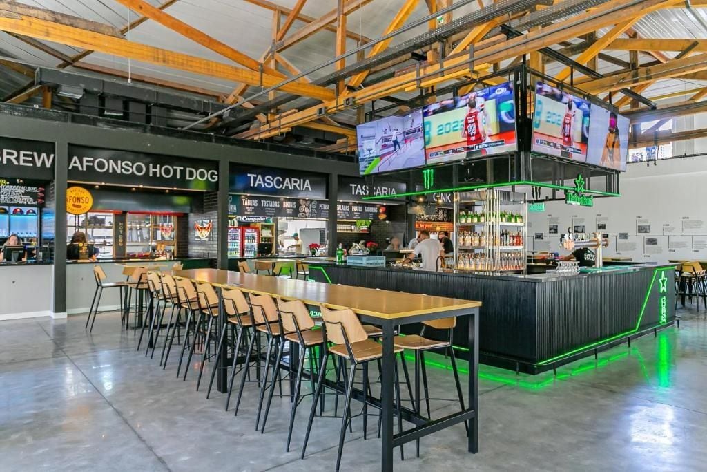 A modern bar area with multiple seating options and a counter.