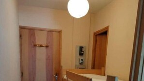 A narrow room with a bunk bed, a wooden door, and a small bedside table. - Appartement au Pied des Pistes du Col du Rousset (Saint-Agnan-en-Vercors)