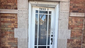 A white door with the number 5605.