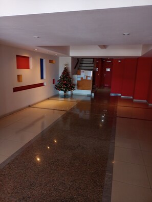 Stunning corridor with a festive touch, featuring a decorated tree and geometric patterns on the walls.