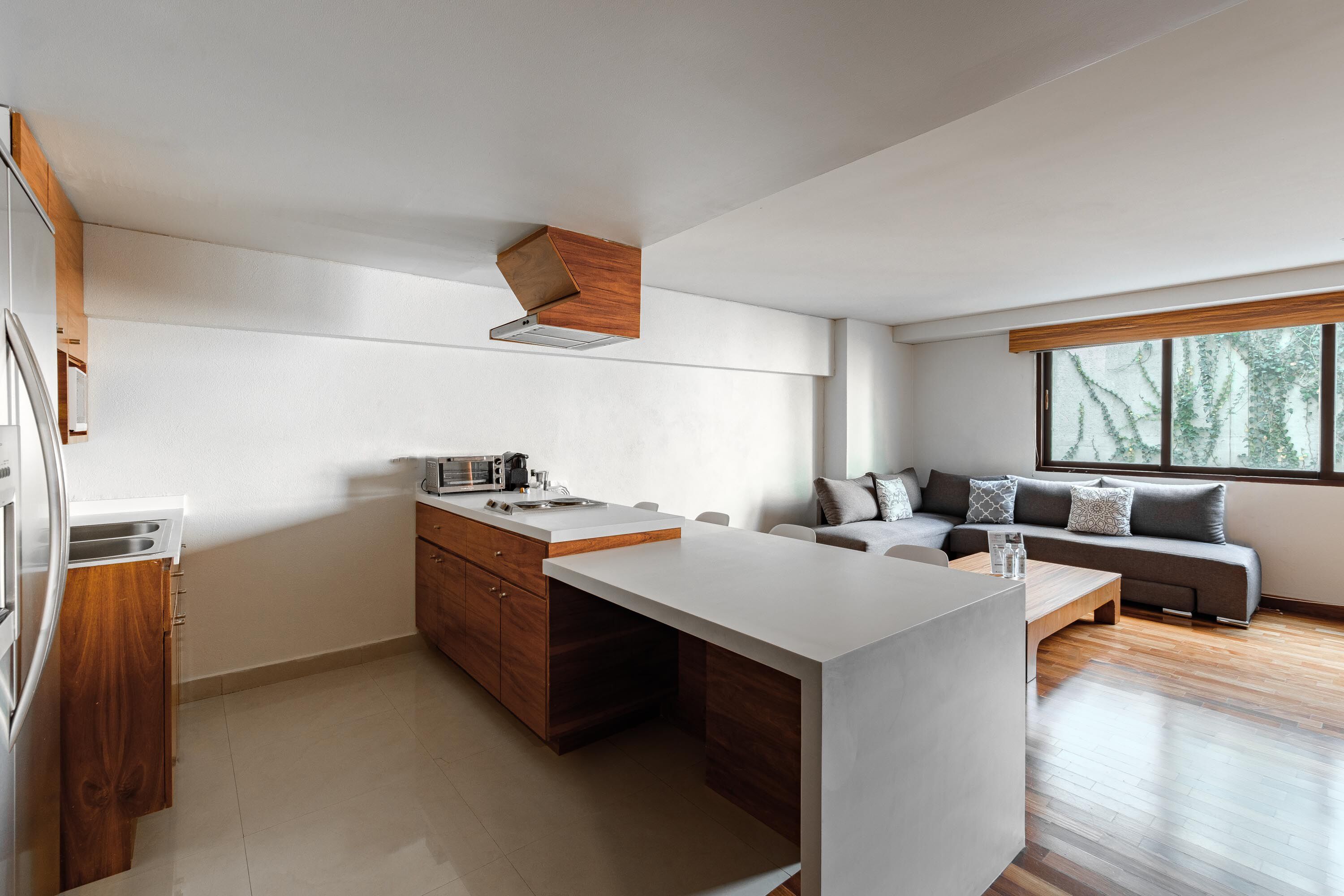 Une cuisine moderne dotée d’un îlot central, de meubles en bois et d’une cuisinière intégrée.