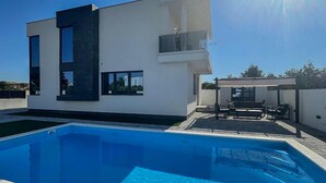 A modern two-story house with a swimming pool in the foreground. - Cozy home in Vodice with sauna (Vodice)