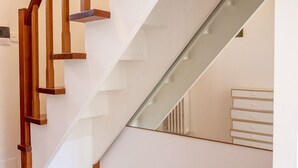 Eine moderne Treppe mit Holzsitzstufen und Glasgeländern.