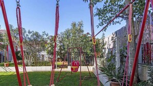 A playground with swings and a slide.