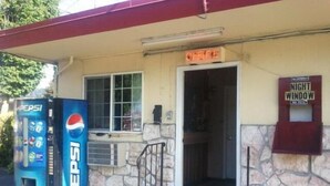 A building with a Pepsi vending machine, a sign reading "OFFICE", and a "NIGHT WINDOW" sign. - Aaron Motel (Portland)