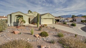 A residential house with a garage, driveway, and desert landscaping. - Green Valley Getaway Near Golfing: Pool Access! (Green Valley)