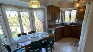 A dining area with a table set for four, surrounded by wooden chairs. - Cozy cottage with a beautiful waterfront view. Pet friendly! 45 min from DC.   (Catharpin)