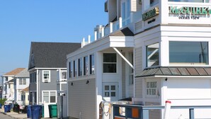 A coastal building with a sign reading "McGurk's Ocean View". - Steps to Hampton Beach and all entertainment! 4 bedrooms, pet friendly! (Hampton)