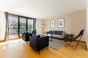 Deluxe Penthouse, 4 Bedrooms | Living area | 45-inch flat-screen TV with cable channels