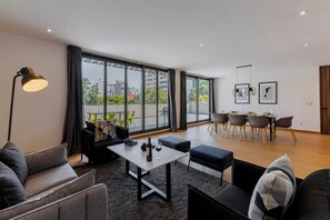 Deluxe Penthouse, 4 Bedrooms | Living area | 45-inch flat-screen TV with cable channels