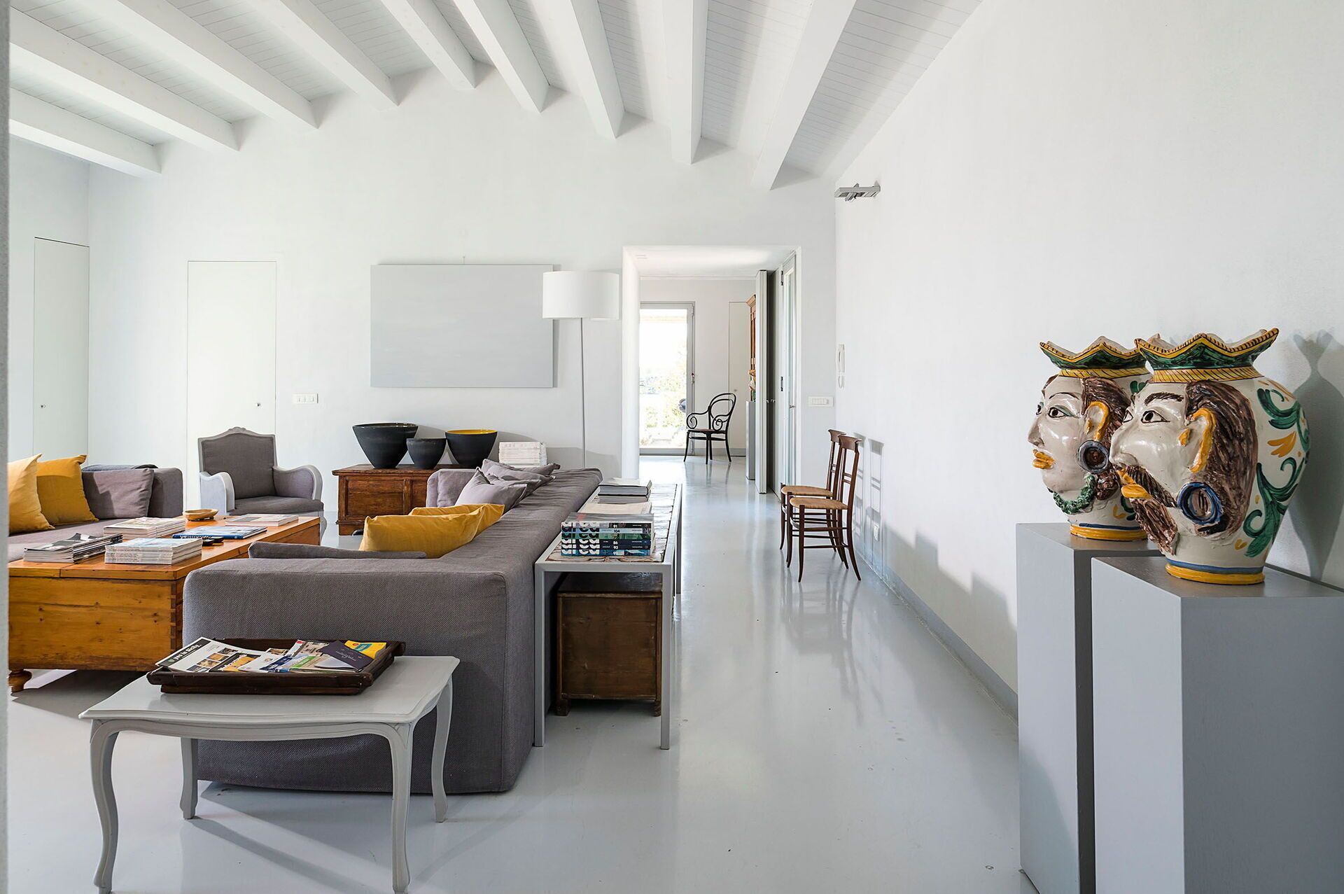 A modern living room with a sofa, coffee table, and decorative items.
