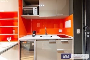 A modern kitchen with a microwave, sink, and dishwasher.