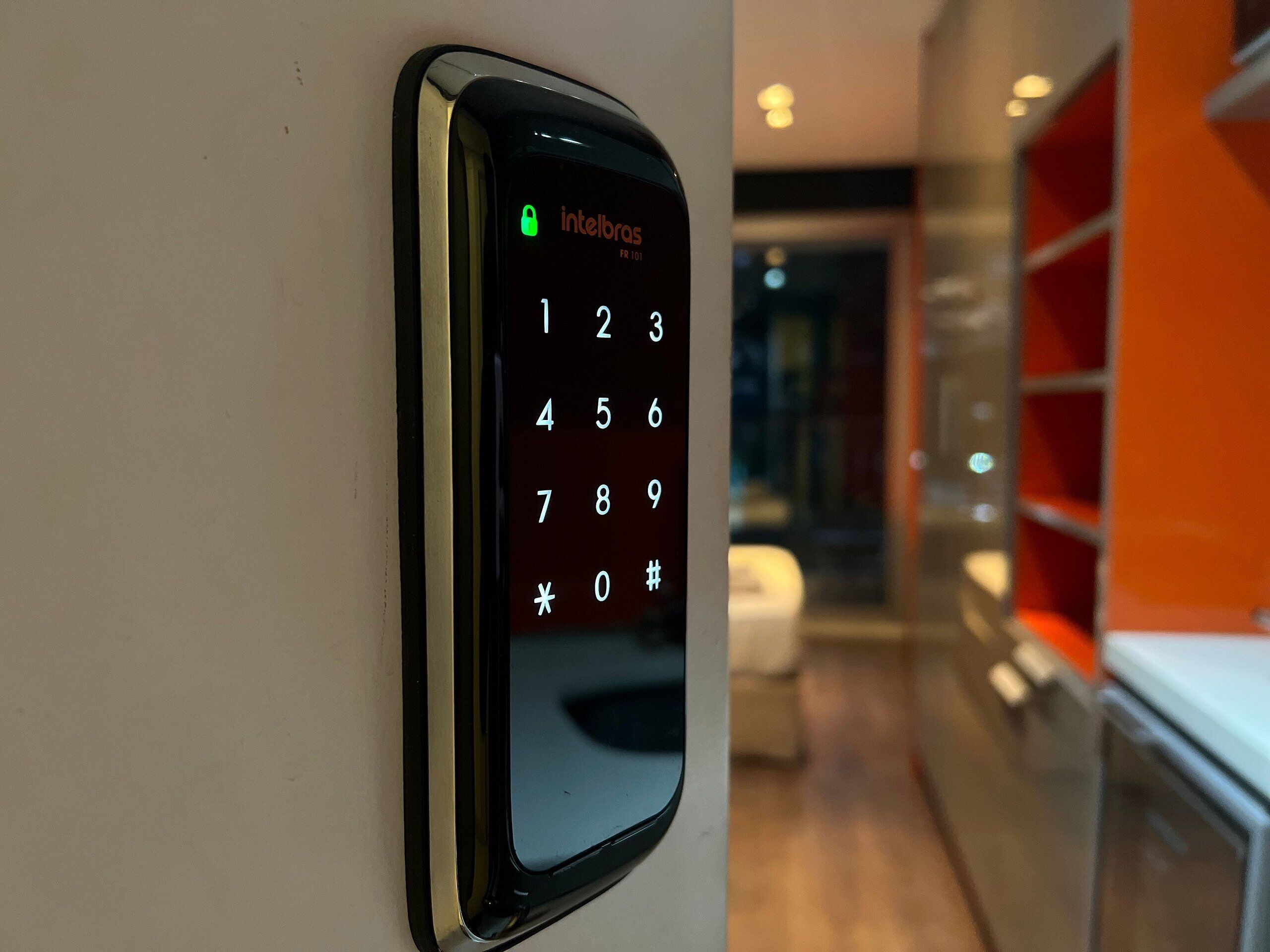 A keypad with the brand name 'Intelbras' and a lock symbol indicating a security feature.