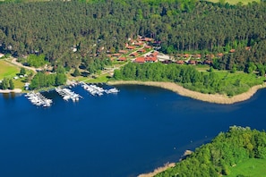 An aerial view of a lakeside property with a marina, surrounded by dense forest. - Holiday Apartment 'Maribell Jabel' with Lake View, Terrace and Wi-Fi (Jabel)