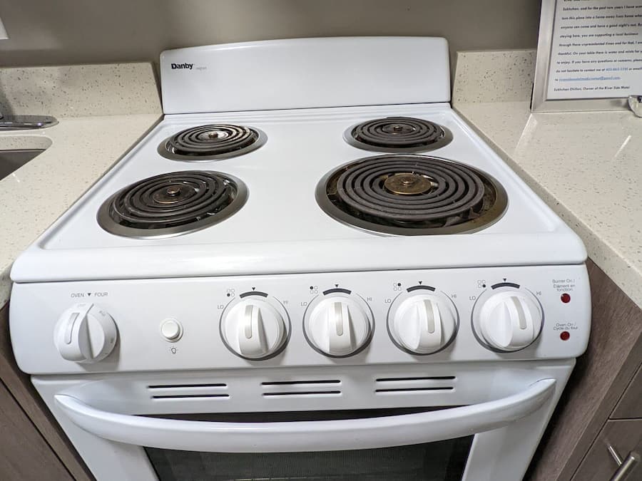 A white Danby oven with four burners, a control panel with knobs, and a built-in oven below.