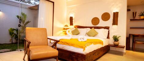 A bedroom with a wooden bed, a chair, and a small table.