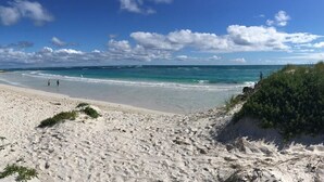 A beach with white sand, clear turquoise water, and sparse vegetation. - Tasman Holiday Parks - Ledge Point (Ledge Point)