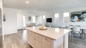 A spacious kitchen with a large island, modern appliances, and ample natural light. - Desert Hot Springs Vacation Home w/ Community Pool (Desert Hot Springs)