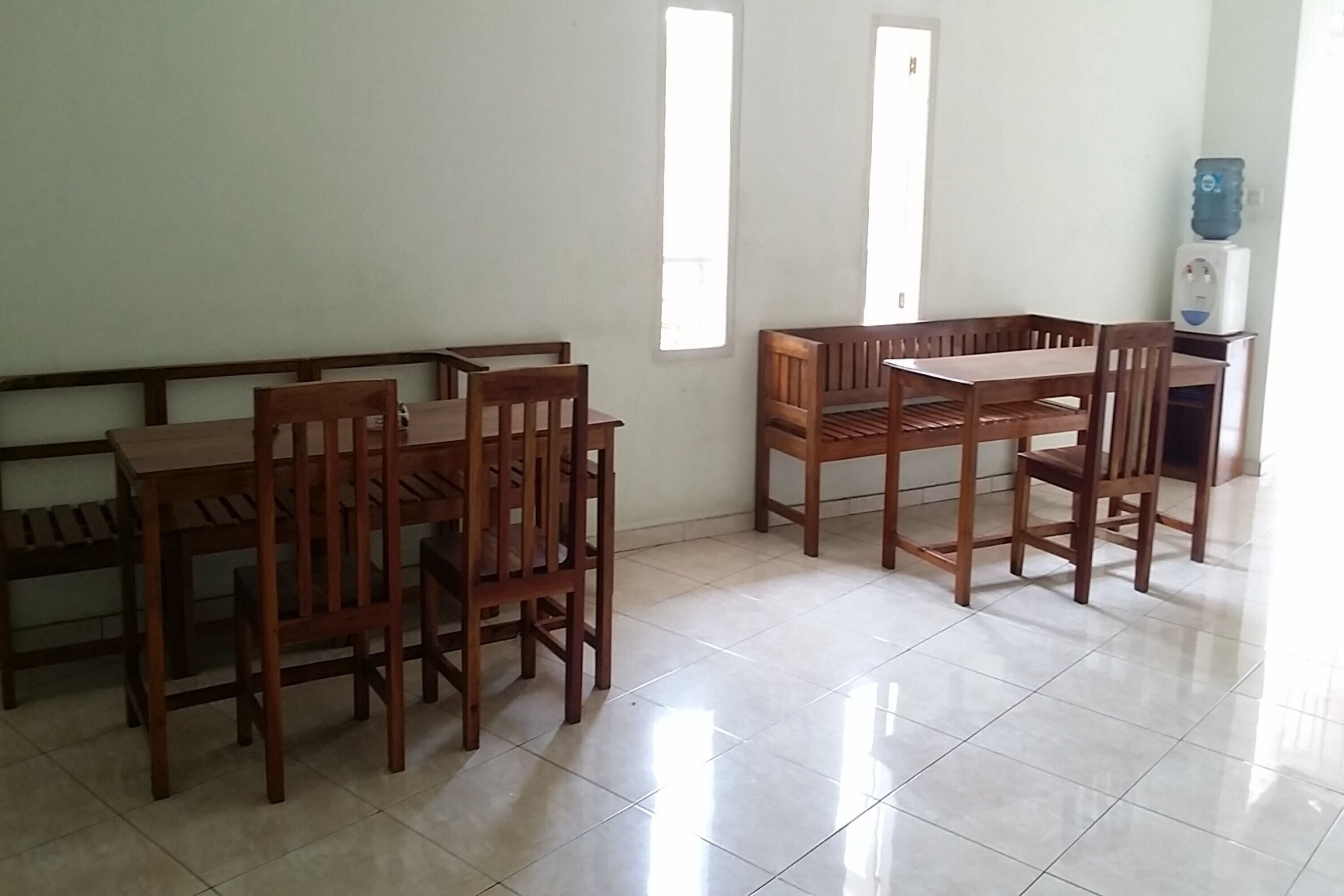 A dining area with wooden furniture and a tiled floor.