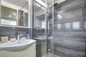 ファミリー アパートメント ベッドルーム (複数) マウンテンサイド (Apartment View And Pool) | バスルーム | シャワー、ヘアドライヤー、タオル、石鹸