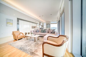 A spacious living area with a sofa, chairs, and a coffee table.