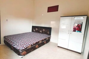 Cozy retreat with a single bed, wardrobe, and mirror.