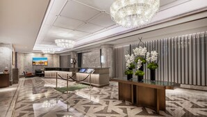 A modern hotel lobby with a reception desk, seating area, and decorative chandeliers. - MaxX by Steigenberger Guangzhou Zhujiang New Town (Guangzhou)