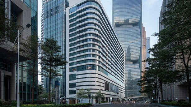 A modern urban street with tall, curved buildings and a clear sky. - MaxX by Steigenberger Guangzhou Zhujiang New Town (Guangzhou)