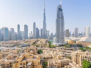 A cityscape with modern high-rise buildings, including a prominent skyscraper with a unique design.