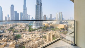 A high-rise building with a view of the Dubai skyline, including the Burj Khalifa and Emaar buildings. - Eloquent Upscale with Breathtaking Burj (Dubai)