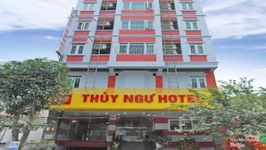 A multi-story hotel with a prominent yellow and red sign reading "THUY NGU HOTEL". - Thuy Ngu by Bay Luxury (Hanoi)