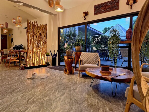 A modern interior with a large window, wooden furniture, and a decorative wall piece.