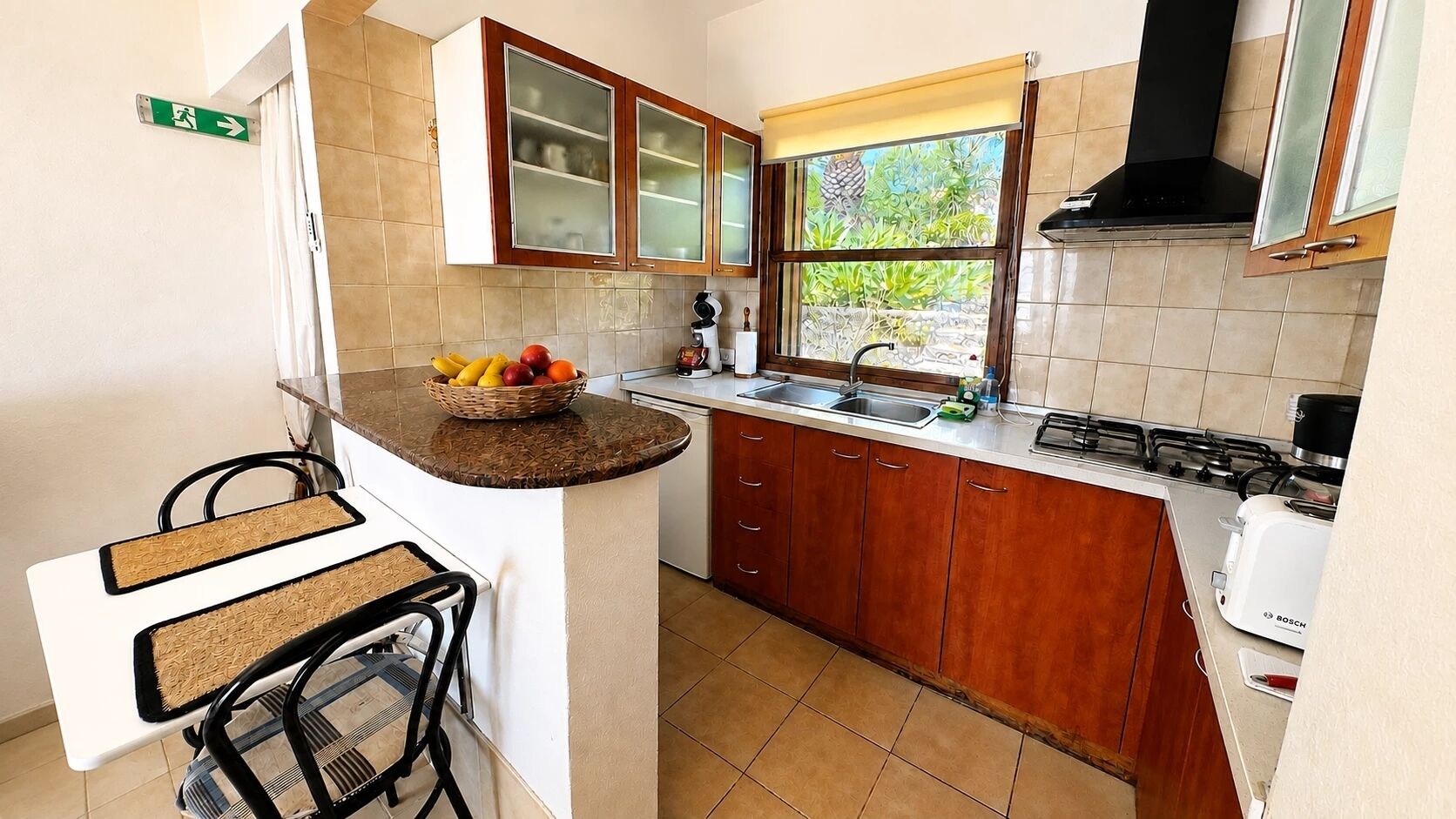 A compact kitchen with a built-in island, a sink, and a stove.