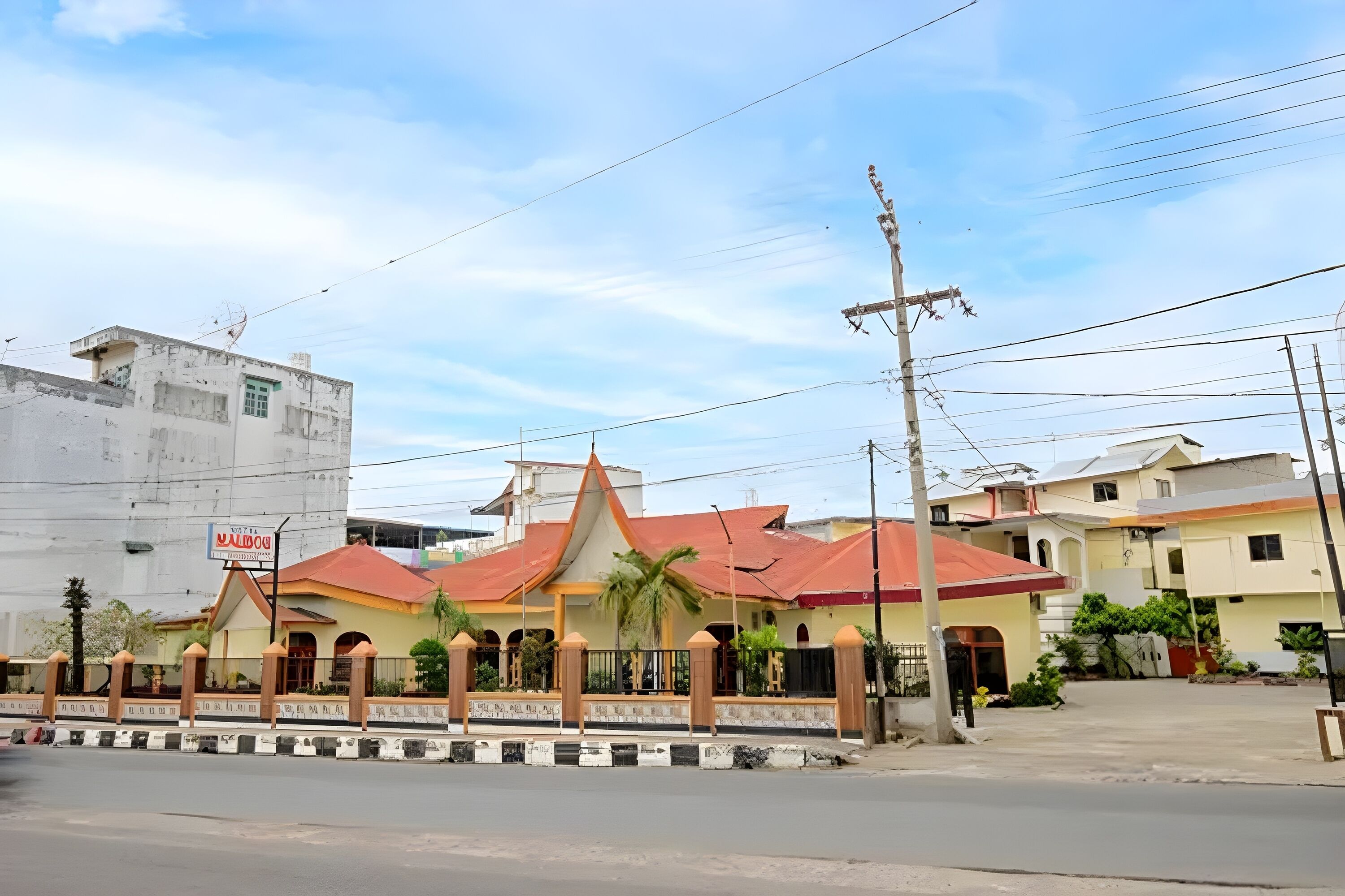 A building with a red roof and a signboard.