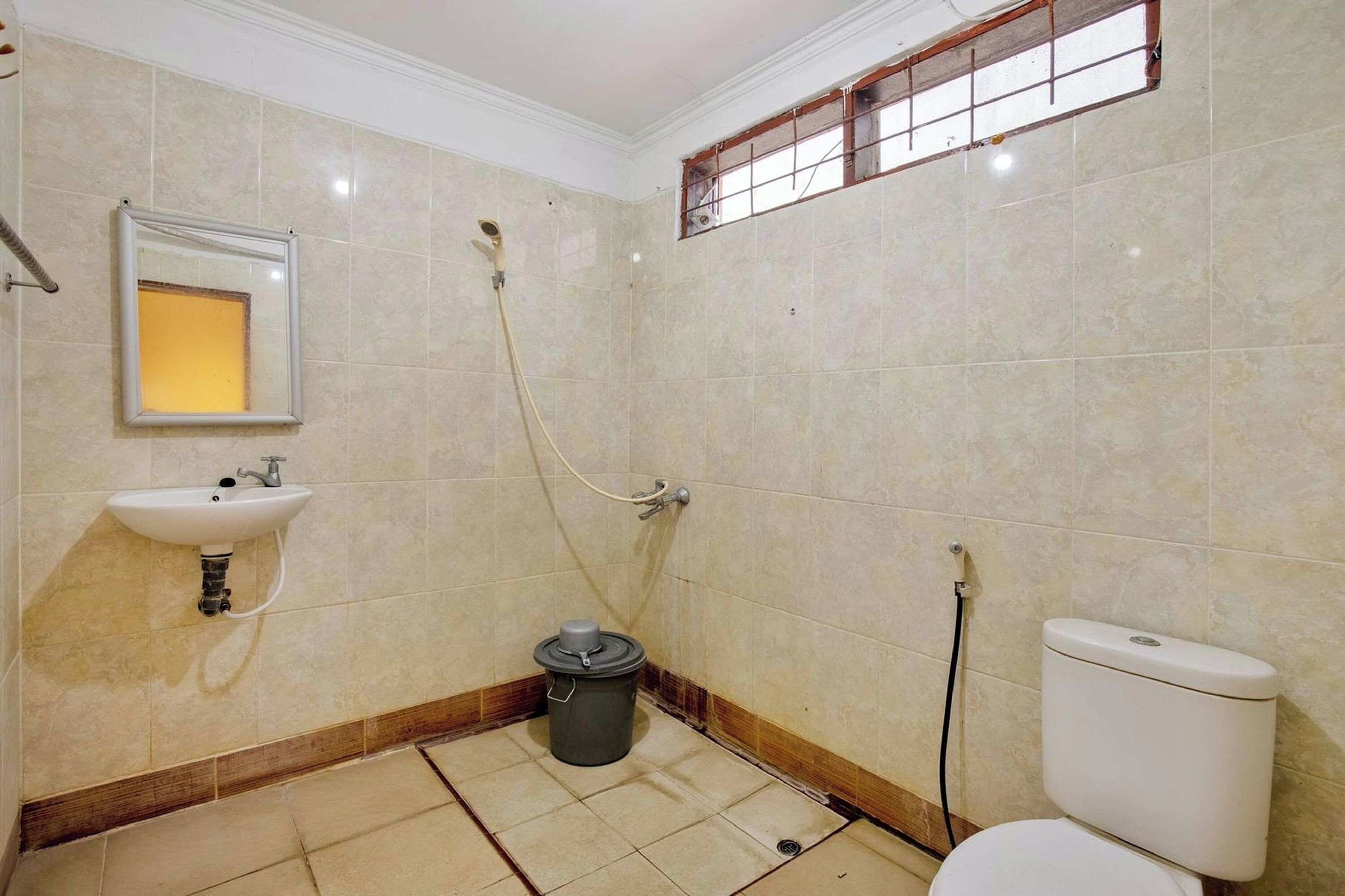 A small bathroom with a sink, toilet, and shower.