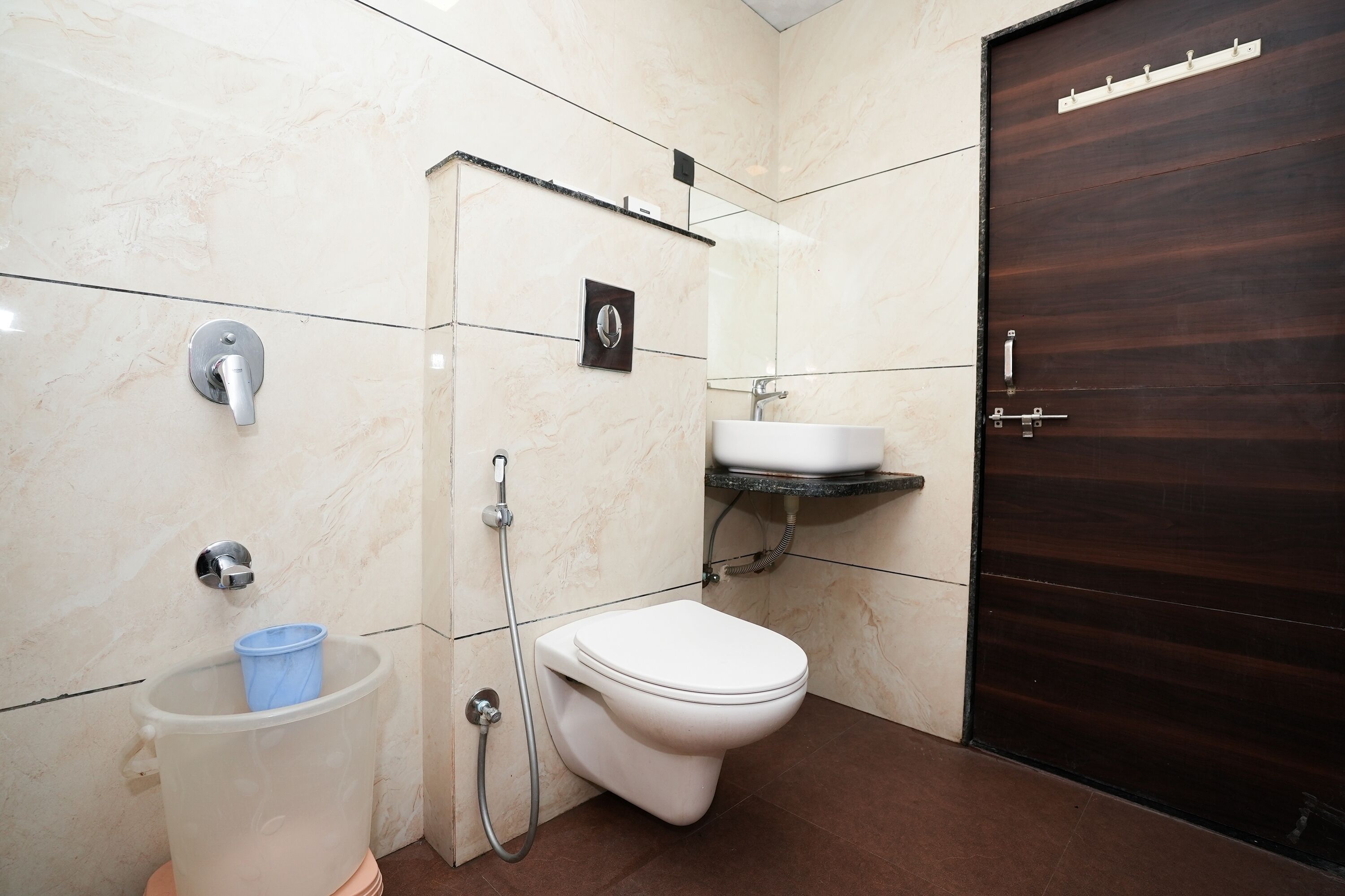 A bathroom with a toilet, sink, and shower.