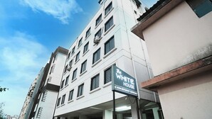 A multi-story building with a sign for "The White House" indicating it is an AC room restaurant. - The White House (Pune)