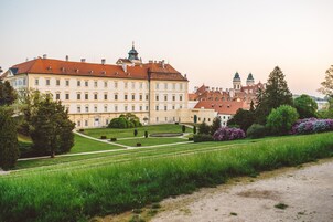 A large, historic building with a symmetrical facade, multiple windows, and a central courtyard.